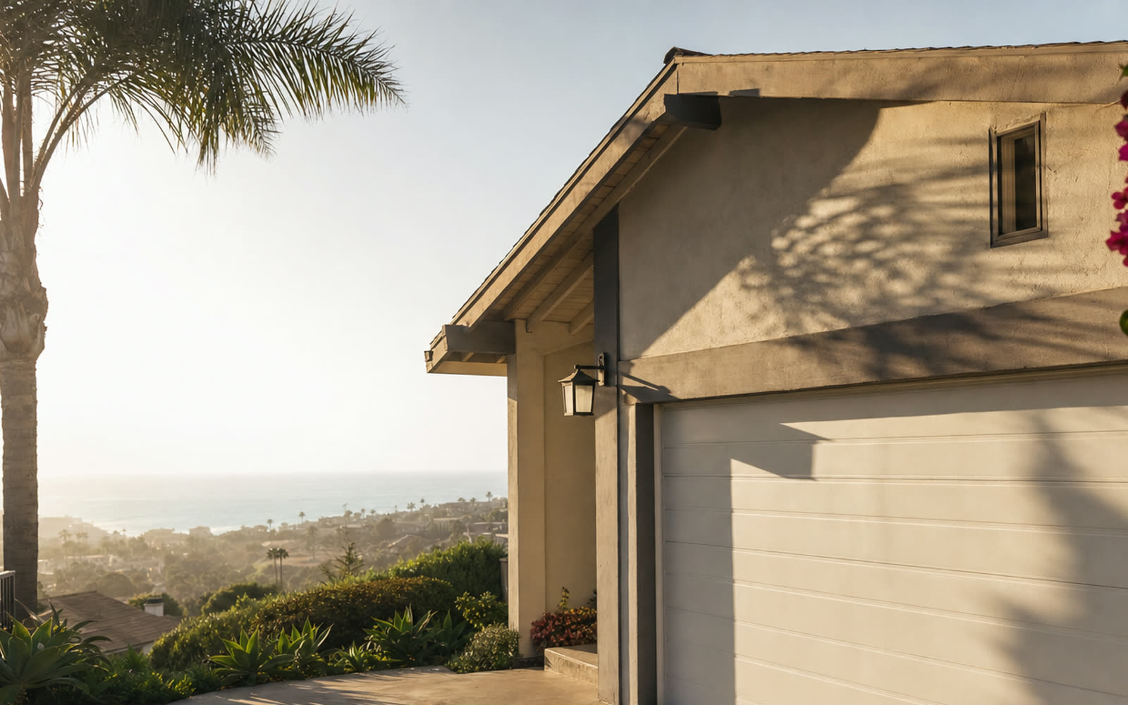 Morning coastal light on a San Diego home with a clean sectional garage door